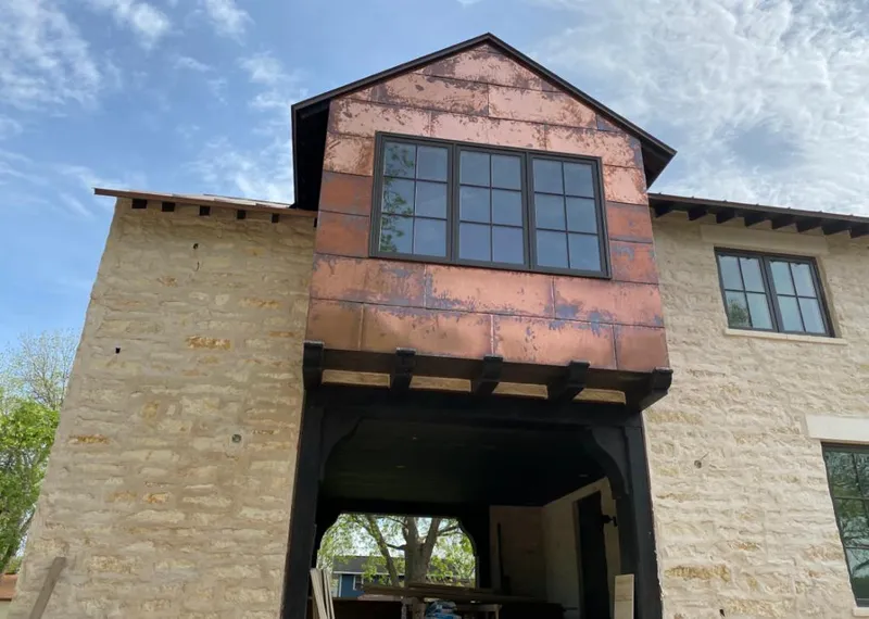 Copper metal panel facade on a stone building for Metal Roof Coating in Steele Creek
