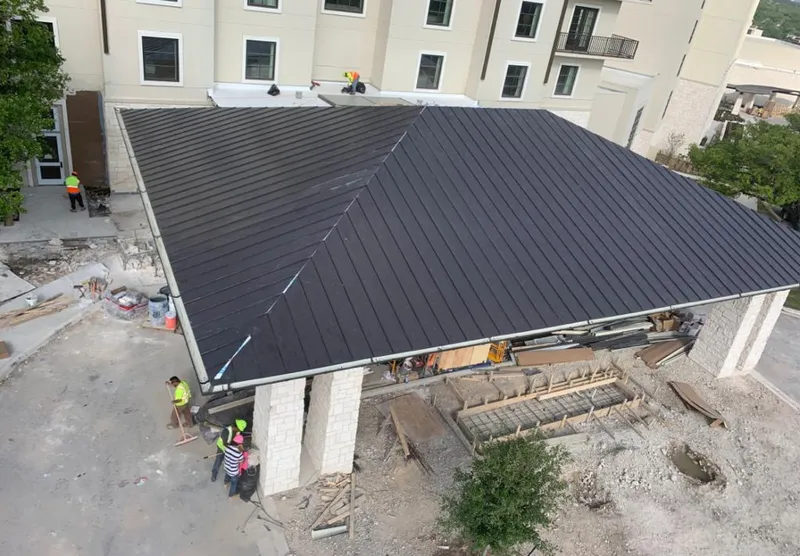Metal roofing installation team working on a commercial building in Steele Creek